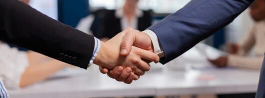 satisfied businessman company employer wearing suit handshake new employee get hired job interview man hr manager employ successful candidate shake hand business meeting placement concept e1633943263358